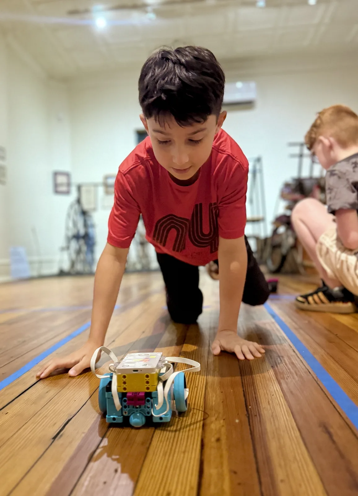 Student driving a robot in the arena