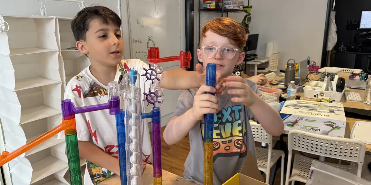 Homeschool students building a marble run together at the Newburgh Creates studio
