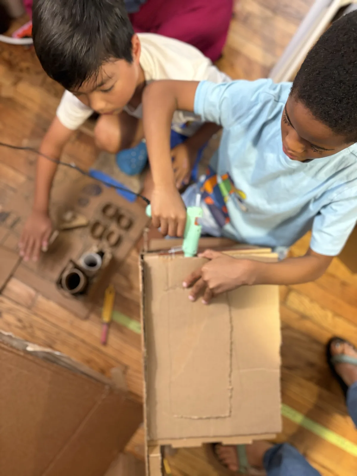 Students building a cardboard city from recycled materials