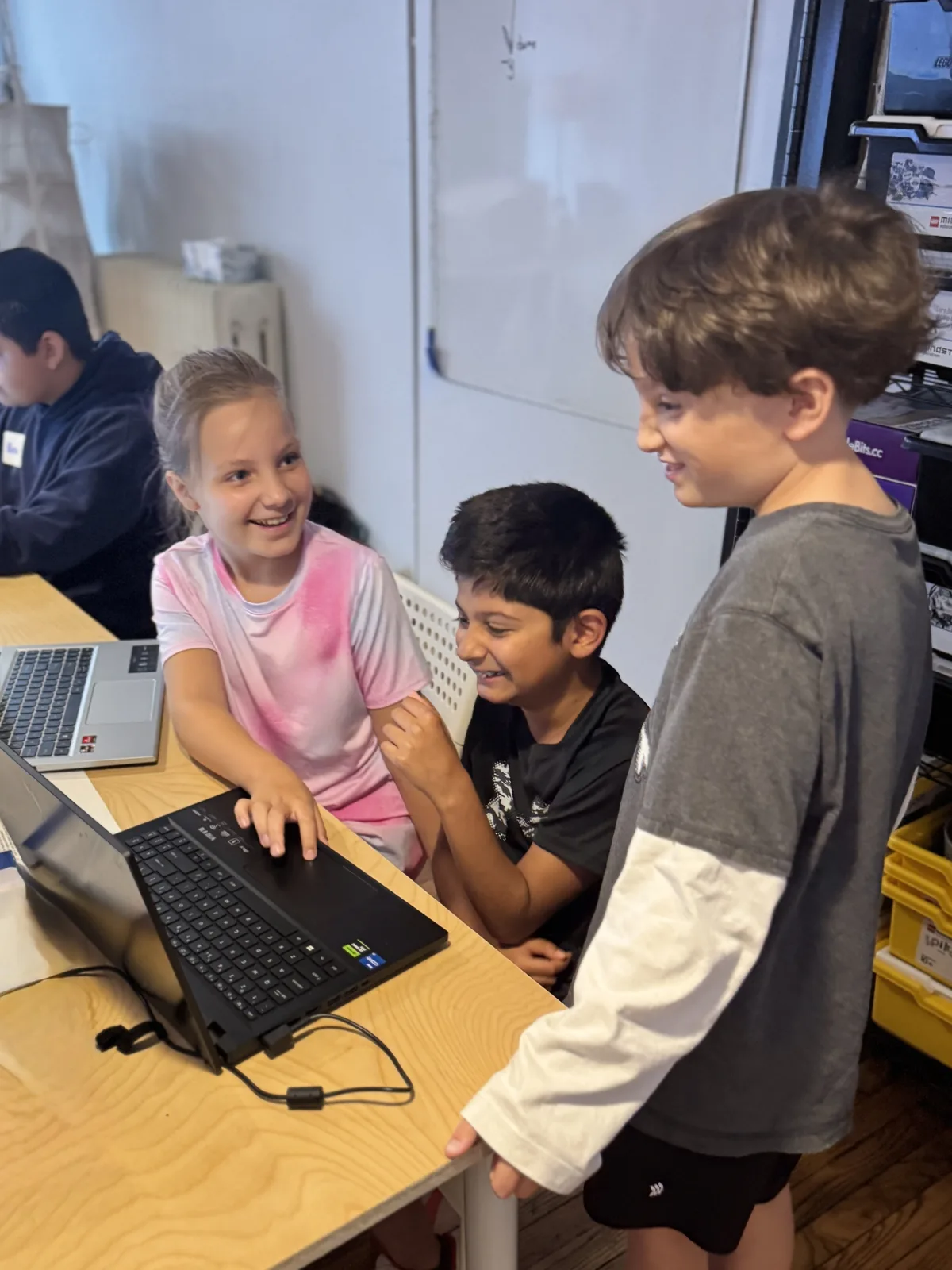 Students laughing together over a laptop