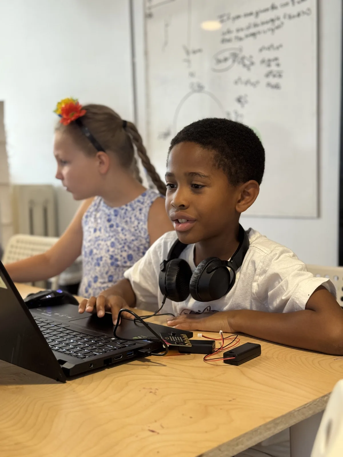 Students drawing together at a laptop
