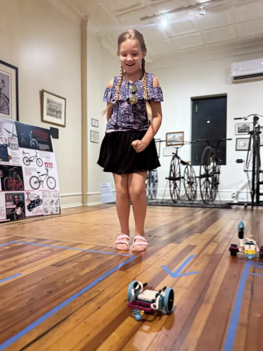 Student with her robot on the test floor