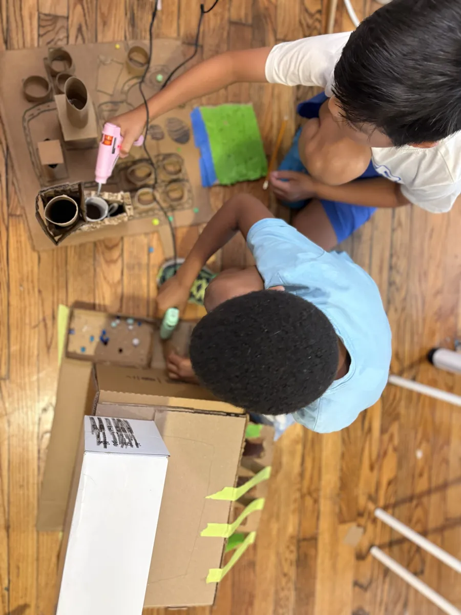Students building cardboard structures