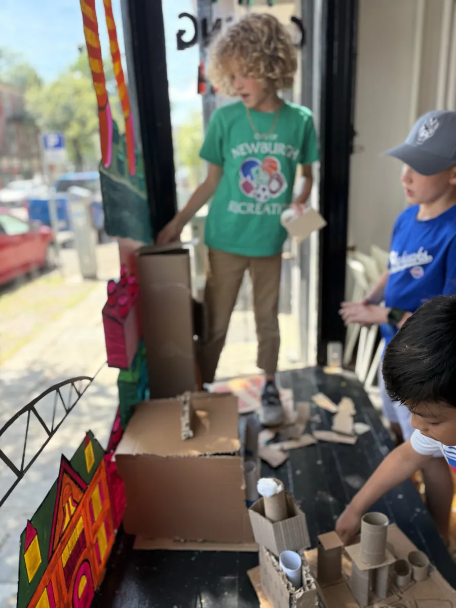 The cardboard city growing in the studio window