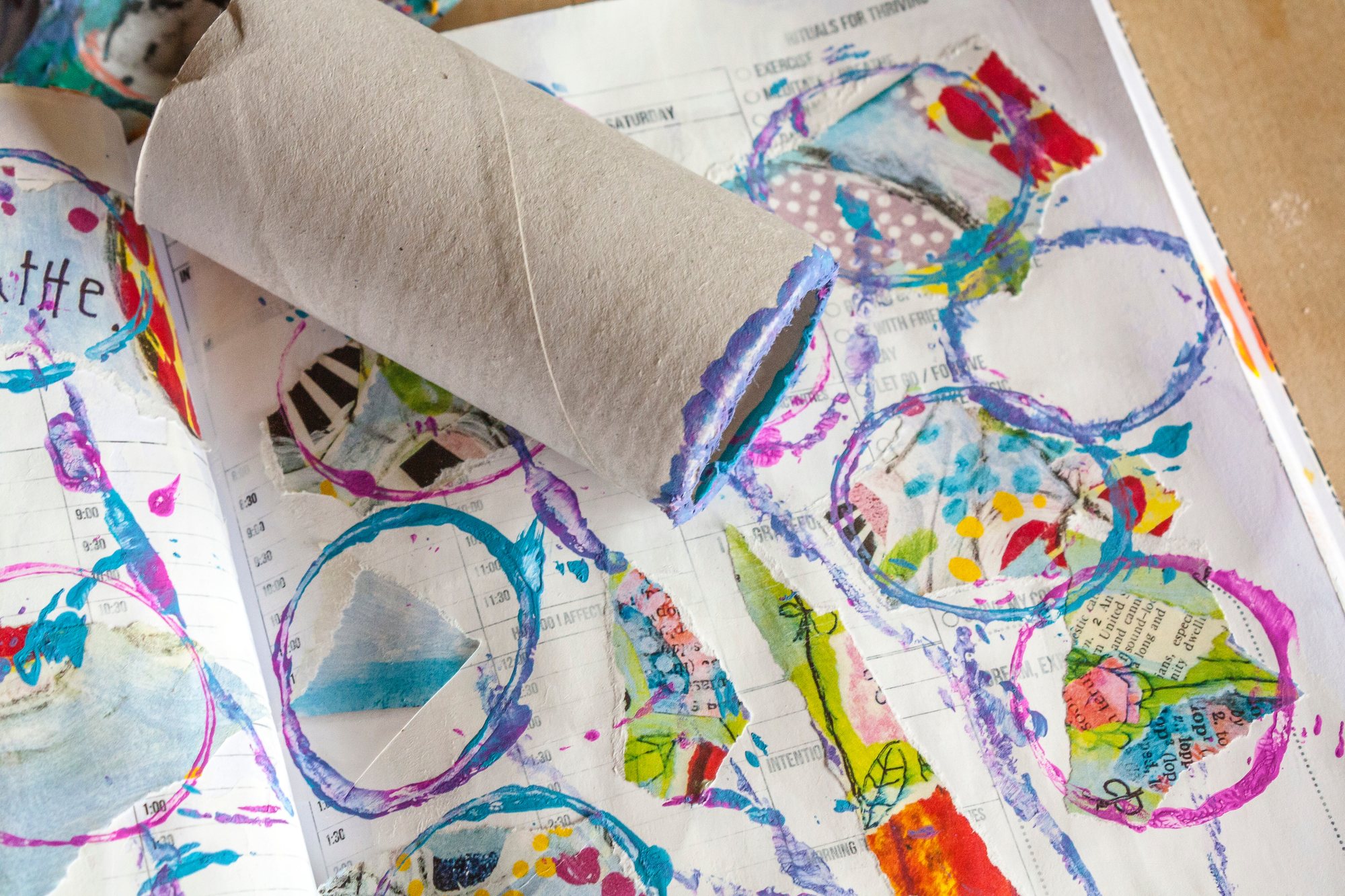 A mixed-media art journal spread with paint and collage