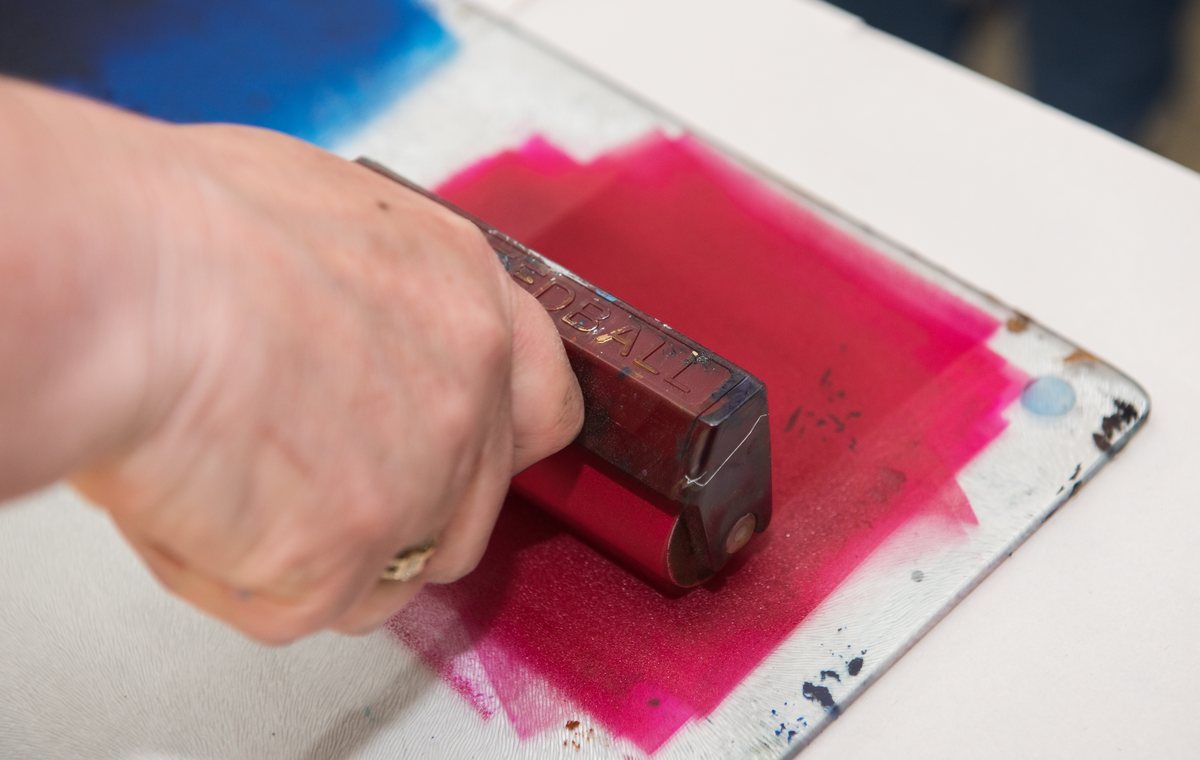 Rolling ink with a brayer in the printmaking studio