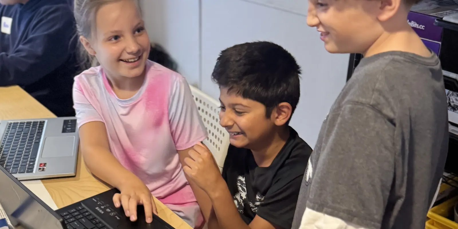 Campers working together at a laptop